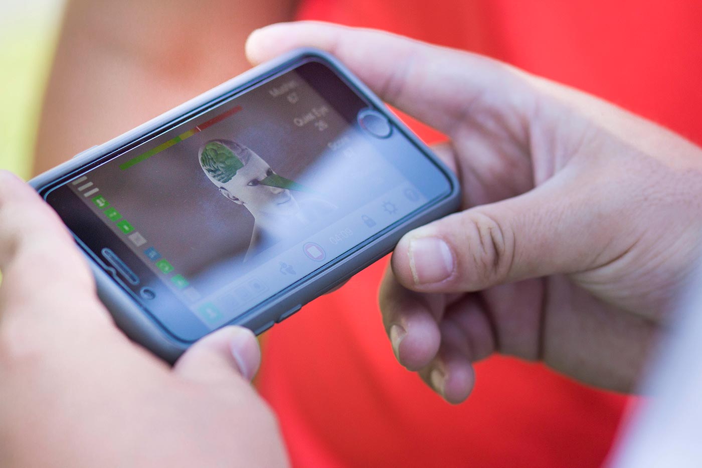 Golfer looking at cell phone app with human brain diagram.