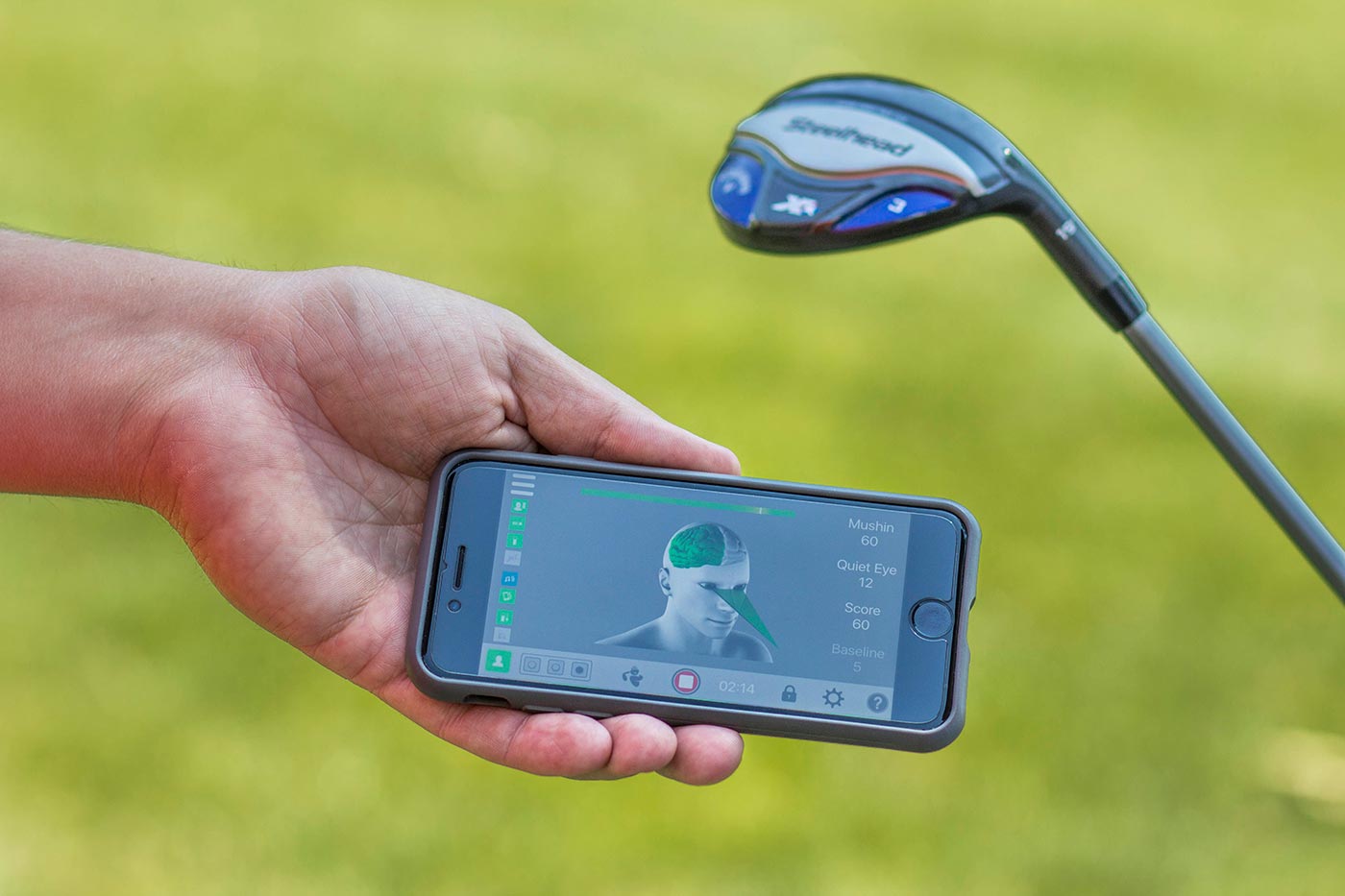 Golfer looking at cell phone app with human brain diagram.