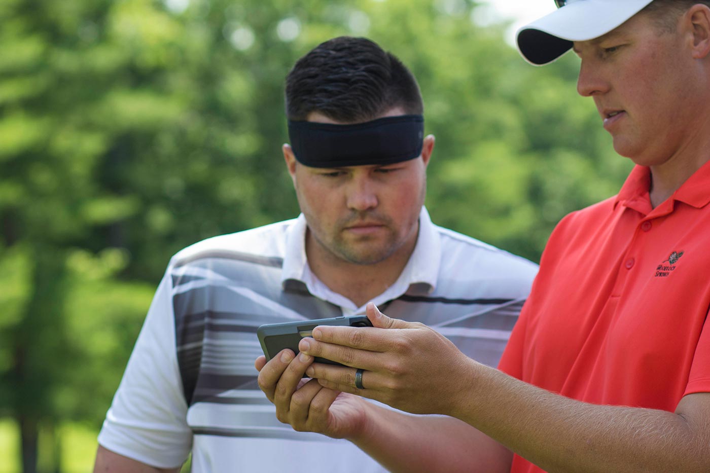 Golfer with sweatband/monitor.