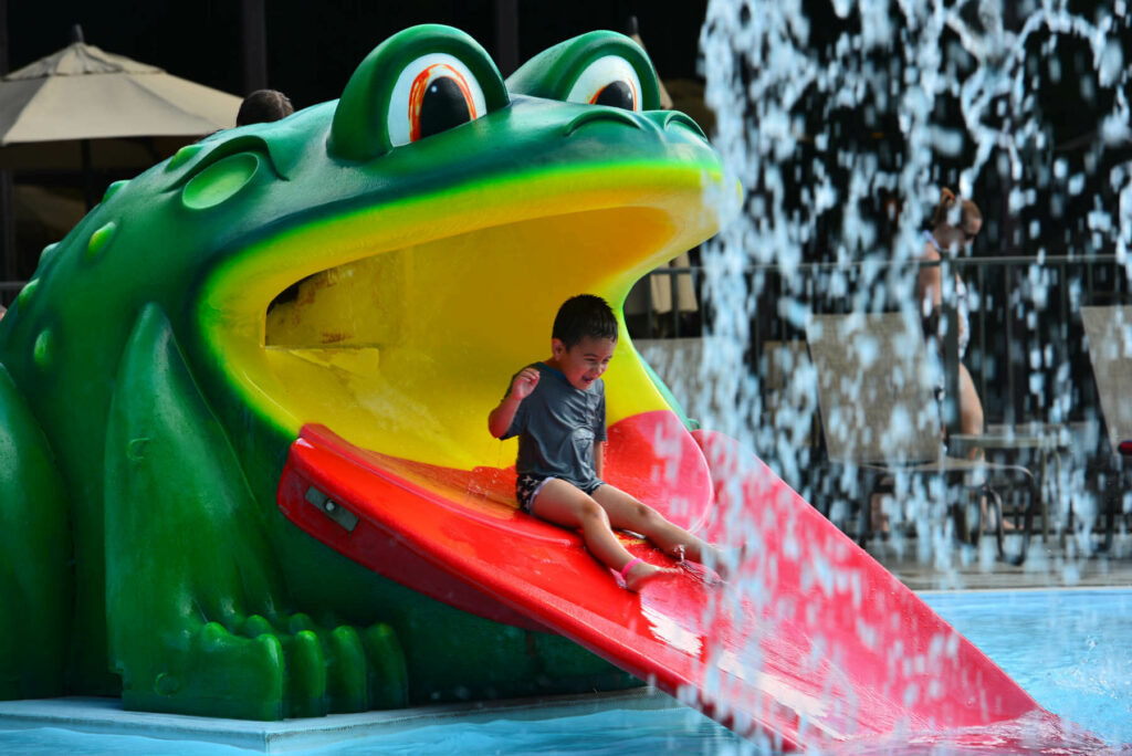 Photo of child having fun on a slide with our Poconos indoor activities at Woodloch