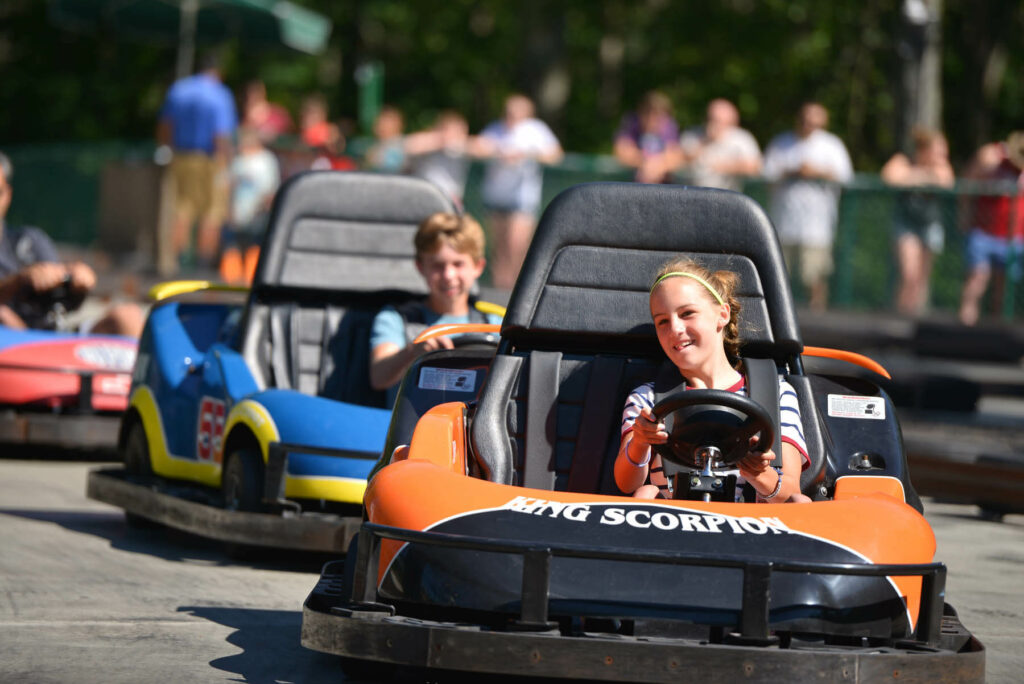 People riding go karts, one of the free things to do in the Poconos for guests at Woodloch.