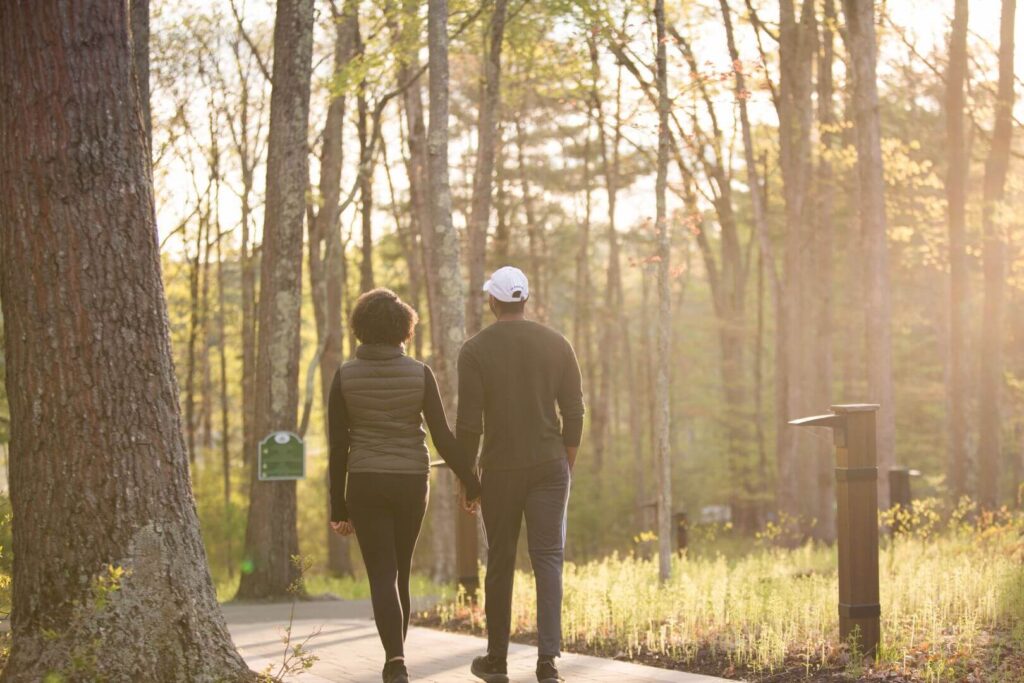 Two people going for a walk at one of the best Poconos resorts for couples.