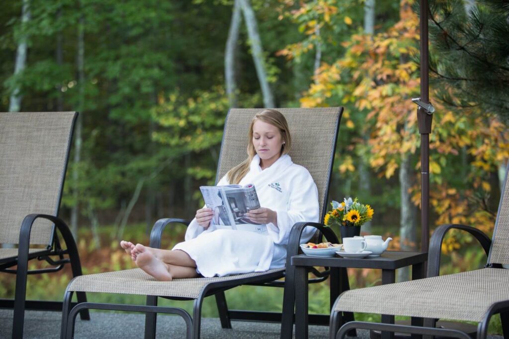 A woman relaxing on a solo vacation in the Poconos.