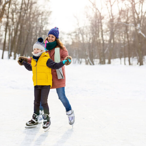 A mom and child ice skating at one of the winter attractions in the Poconos.